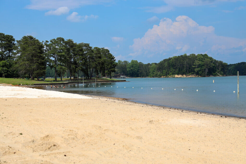 A sandy day-use beach with a roped swim area on Lake Lanier