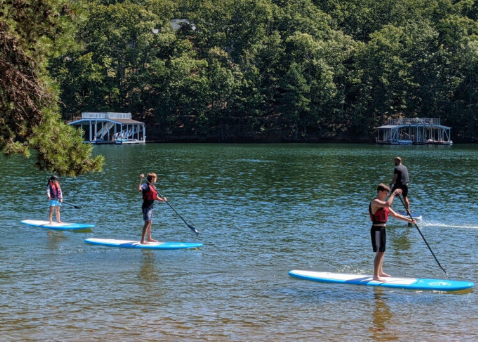 Kayaks and paddleboards at the beach at Mary Alice Park on Lake Lanier