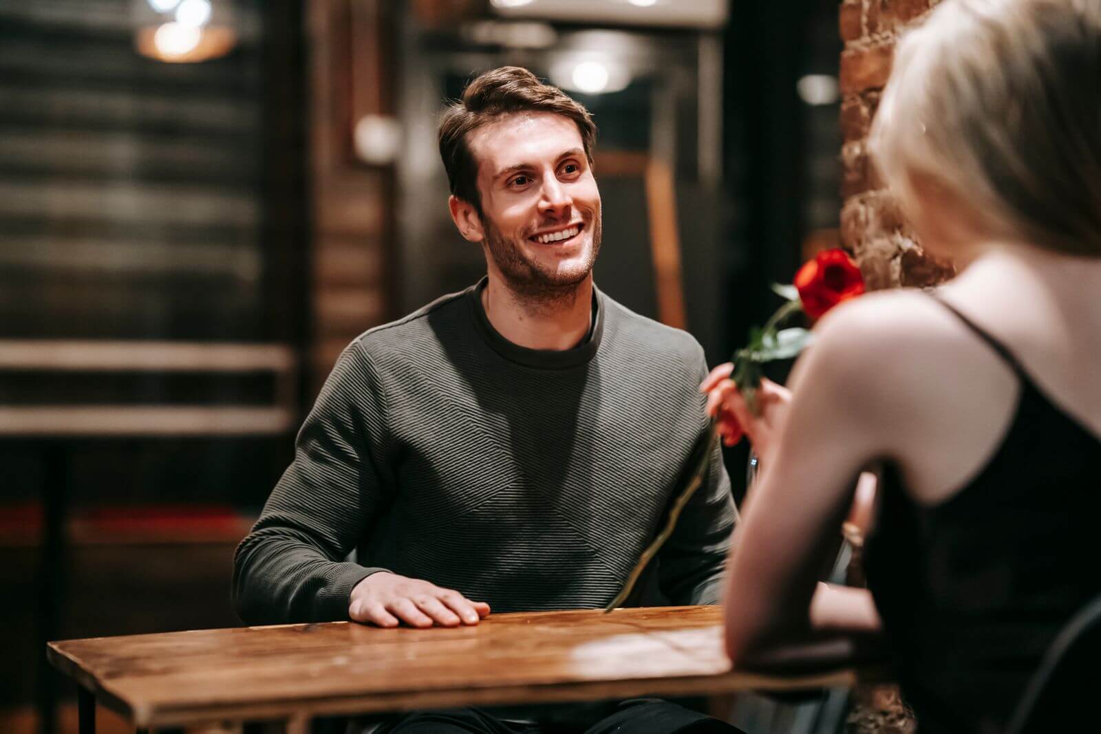 Happy couple sitting at a cafe table on a date
