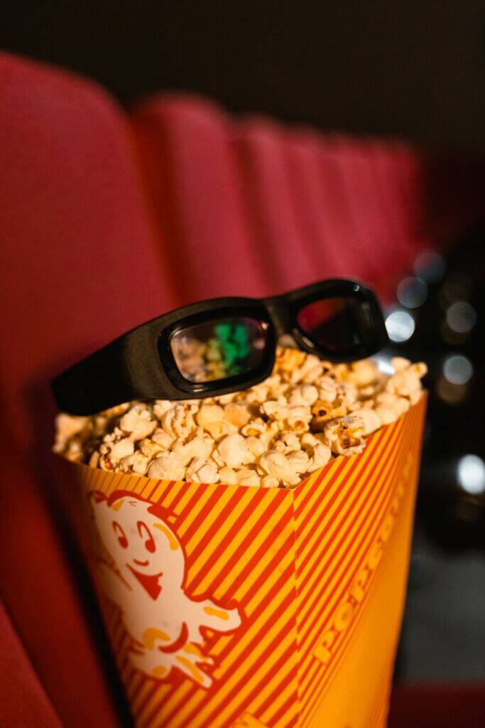 3D glasses resting on a bucket of popcorn for movie night